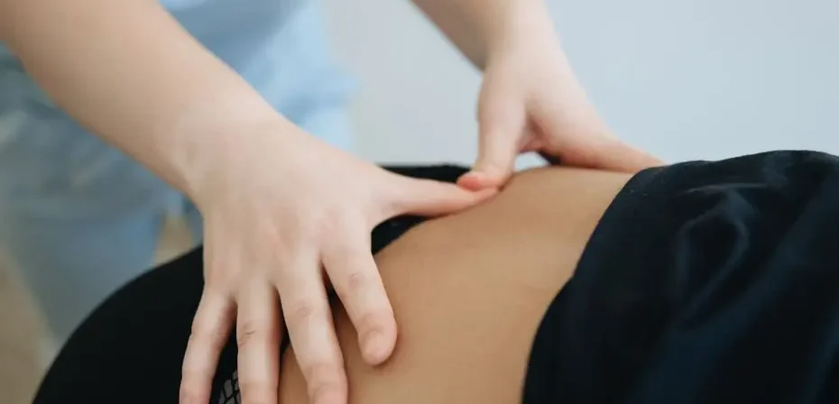 Gros plan sur un thérapeute pratiquant un massage du dos.